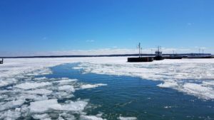 ice formations on blue waters of lake superior with blue skies with white clouds