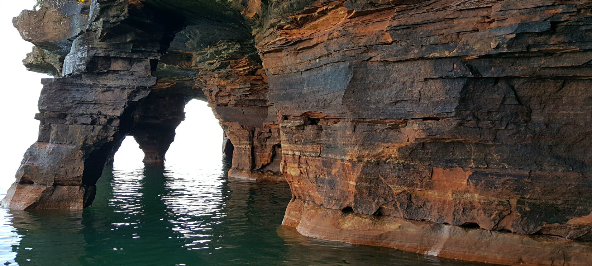 Large colorful rock formation in a body of water